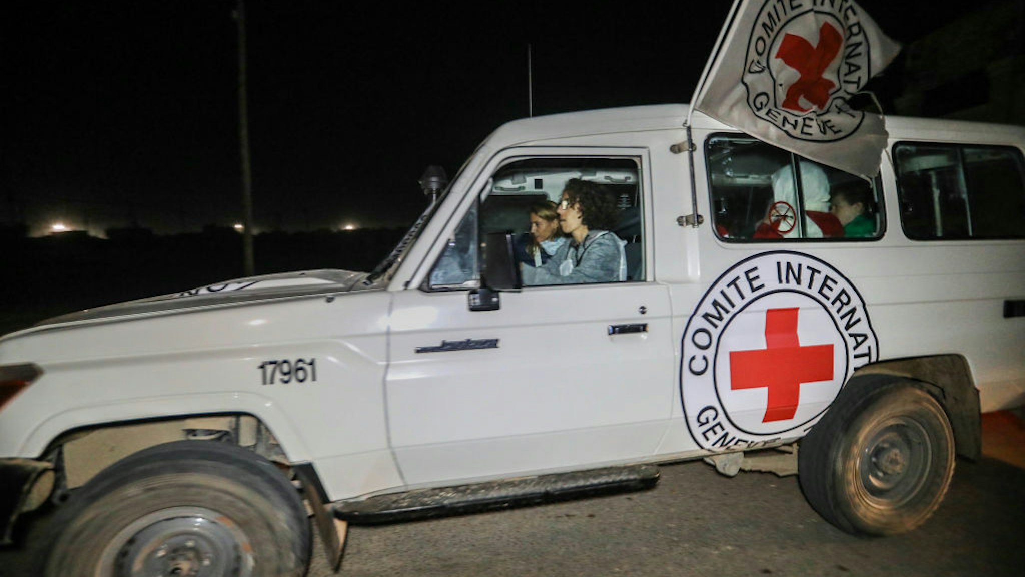RAFAH, GAZA - NOVEMBER 30: Hostages are transported in International Committee of the Red Cross vehicles from the Gaza Strip through the Rafah land crossing on November 30, 2023 in Rafah, Gaza. Israel and Hamas agreed to a further extension to a truce that has lasted nearly a week, which promised the release of more Israeli hostages held in Gaza, as well as the release of Palestinian prisoners held in Israeli jails. (Photo by Ahmad Hasaballah/Getty Images)