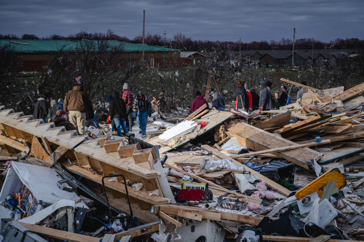 CLARKSVILLE, TENNESSEE - DECEMBER 10: Residents and visitors work to clear debris in search of pets and belongings of a destroyed home in the aftermath of a tornado on December 10, 2023 in Clarksville, Tennessee. Multiple long-track tornadoes were reported in northwest Tennessee on December 9th causing multiple deaths and injuries and widespread damage.