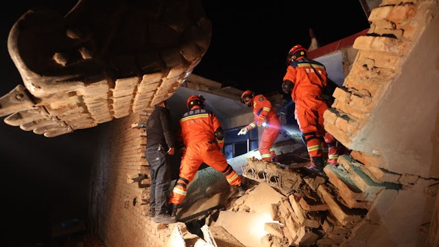 TOPSHOT - Rescue workers search a house for survivors after an earthquake in Kangdiao village, Dahejia, Jishishan County, in northwest China's Gansu province on December 19, 2023. At least 111 people were killed when an earthquake collapsed buildings in northwest China, state media reported on December 19, as rescue workers raced to start digging through rubble. (Photo by AFP) / China OUT