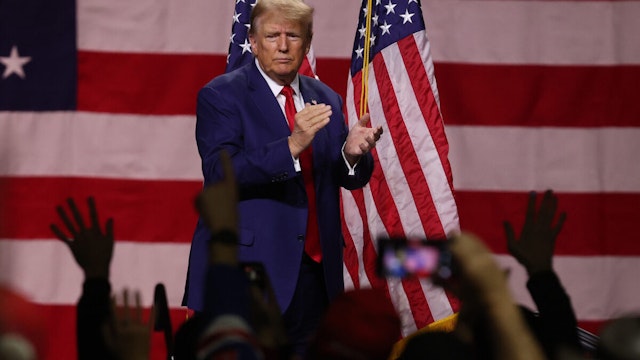 RENO, NEVADA - DECEMBER 17: Republican Presidential candidate former U.S. President Donald Trump claps during a campaign rally at the Reno-Sparks Convention Center on December 17, 2023 in Reno, Nevada. Former U.S. President Trump held a campaign rally as he battles to become the Republican Presidential nominee for the 2024 Presidential election.