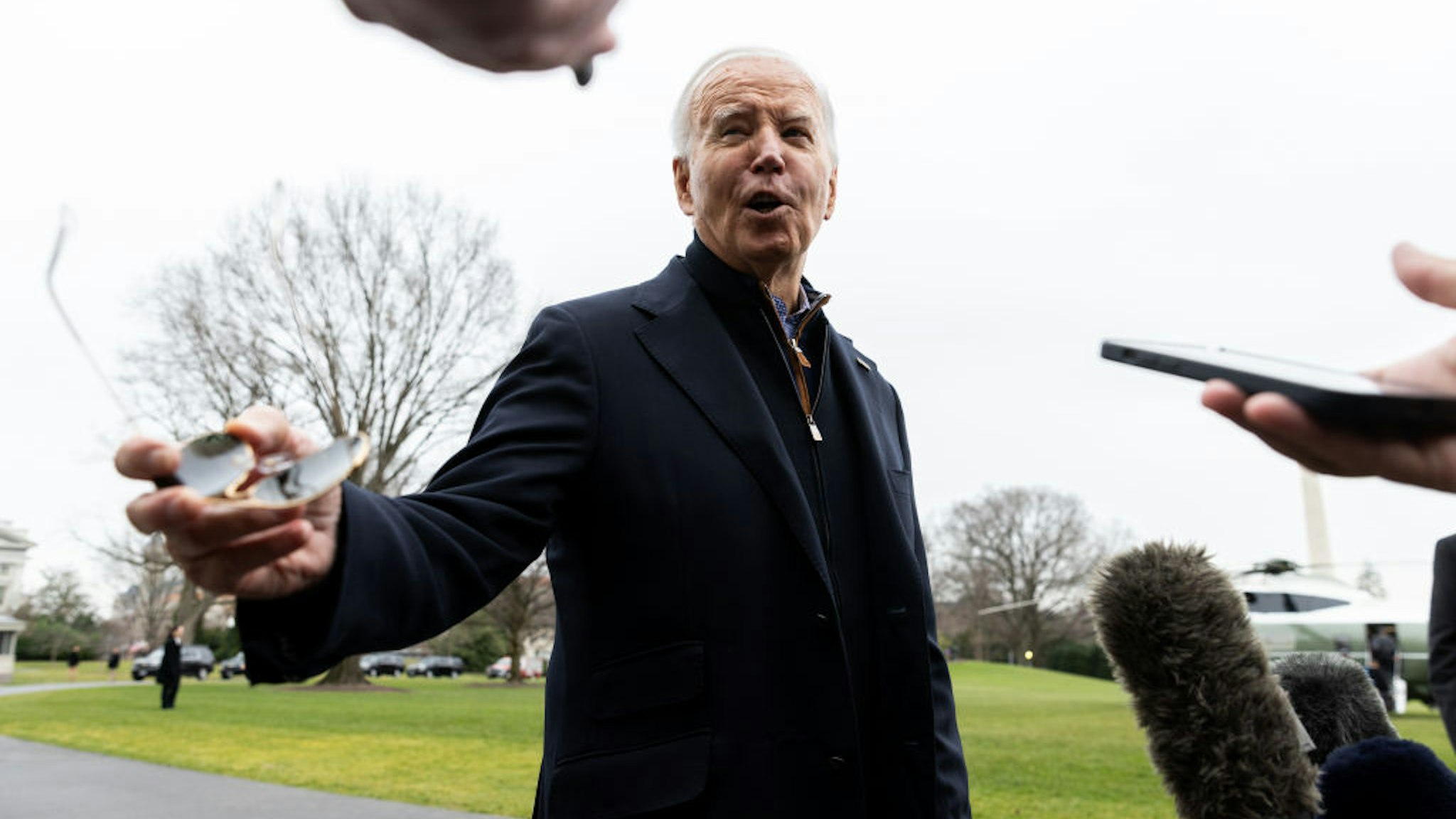 US President Joe Biden speaks to members of the media before boarding Marine One in Washington, DC, US, on Saturday, Dec. 23, 2023. While departing for Camp David, Biden said he "can't think of one" reason presidents should receive absolute immunity from prosecution, as Republican frontrunner Donald Trump has claimed. Photographer: Julia Nikhinson/UPI/Bloomberg via Getty Images