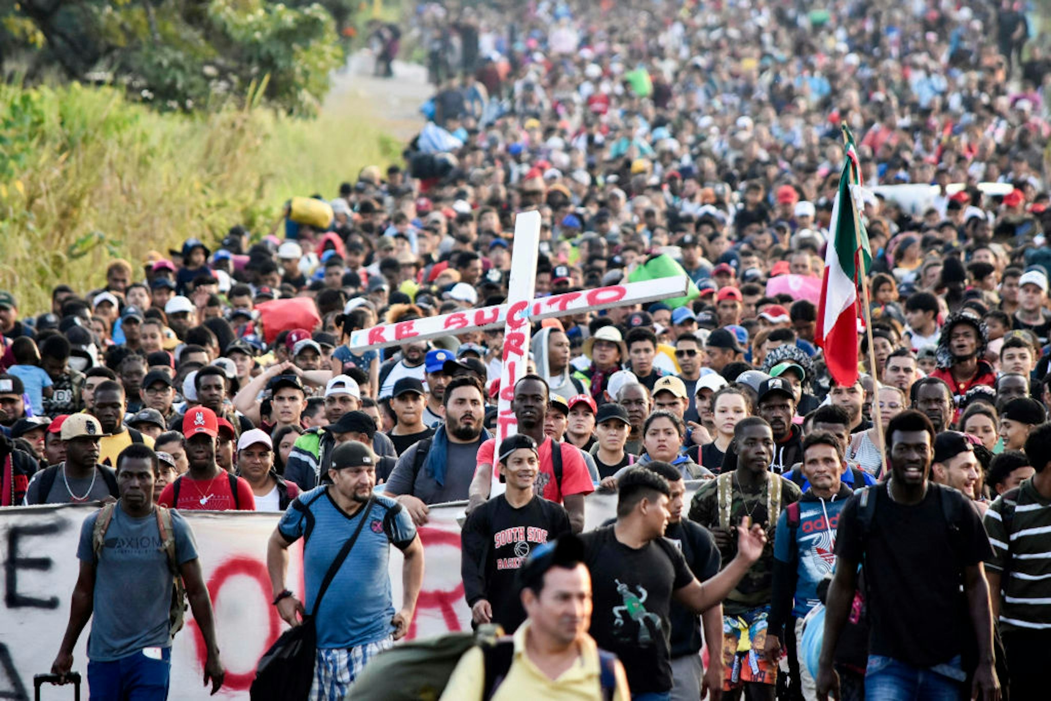 TOPSHOT - Migrants take part in a caravan towards the border with the United States in Tapachula, Chiapas State, Mexico, on December 24, 2023. Mexican President Andres Manuel Lopez Obrador on December 22 said that his government would step up efforts to contain irregular migration flows. Lopez Obrador said the "extraordinary" migration situation would be the focus of talks with Secretary of State Antony Blinken and other senior US officials in Mexico City on Wednesday.