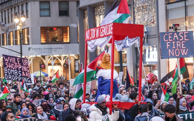 NEW YORK, UNITED STATES - DECEMBER 25: Pro-Palestinian protesters rally in front of the News Corporation building and near the Rockefeller Center Christmas tree, and march on 42nd Street, 5th and Park avenues on Monday, December 25, 2023, in New York City. They chant 'Christmas is canceled' while carrying blood-red mock Nativity scene through New York City streets. The police arrest several protesters and use force while detaining.