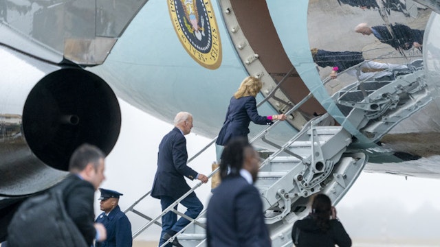 US President Joe Biden, center, and First Lady Jill Biden board Air Force One at Joint Base Andrews, Maryland, US, on Wednesday, Dec. 27, 2023. The White House on Tuesday refused to overturn a sales ban on Apple Inc.'s smartwatches in the US, prompting the tech giant to seek relief in federal court. Photographer: Shawn Thew/EPA/Bloomberg via Getty Images