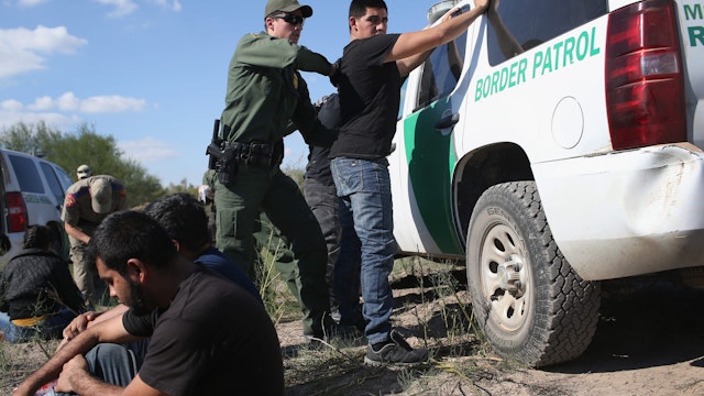 RIO GRANDE CITY, TX - DECEMBER 07: A U.S. Border Patrol officer body searches an undocumented immigrant after he illegally crossed the U.S.-Mexico border and was caught on December 7, 2015 near Rio Grande City, Texas. Border Patrol agents continue to detain hundreds of thousands of undocumented immigrants trying to avoid capture after crossing into the United States, even as migrant families and unaccompanied minors from Central America cross and turn themselves in to seek assylum.
