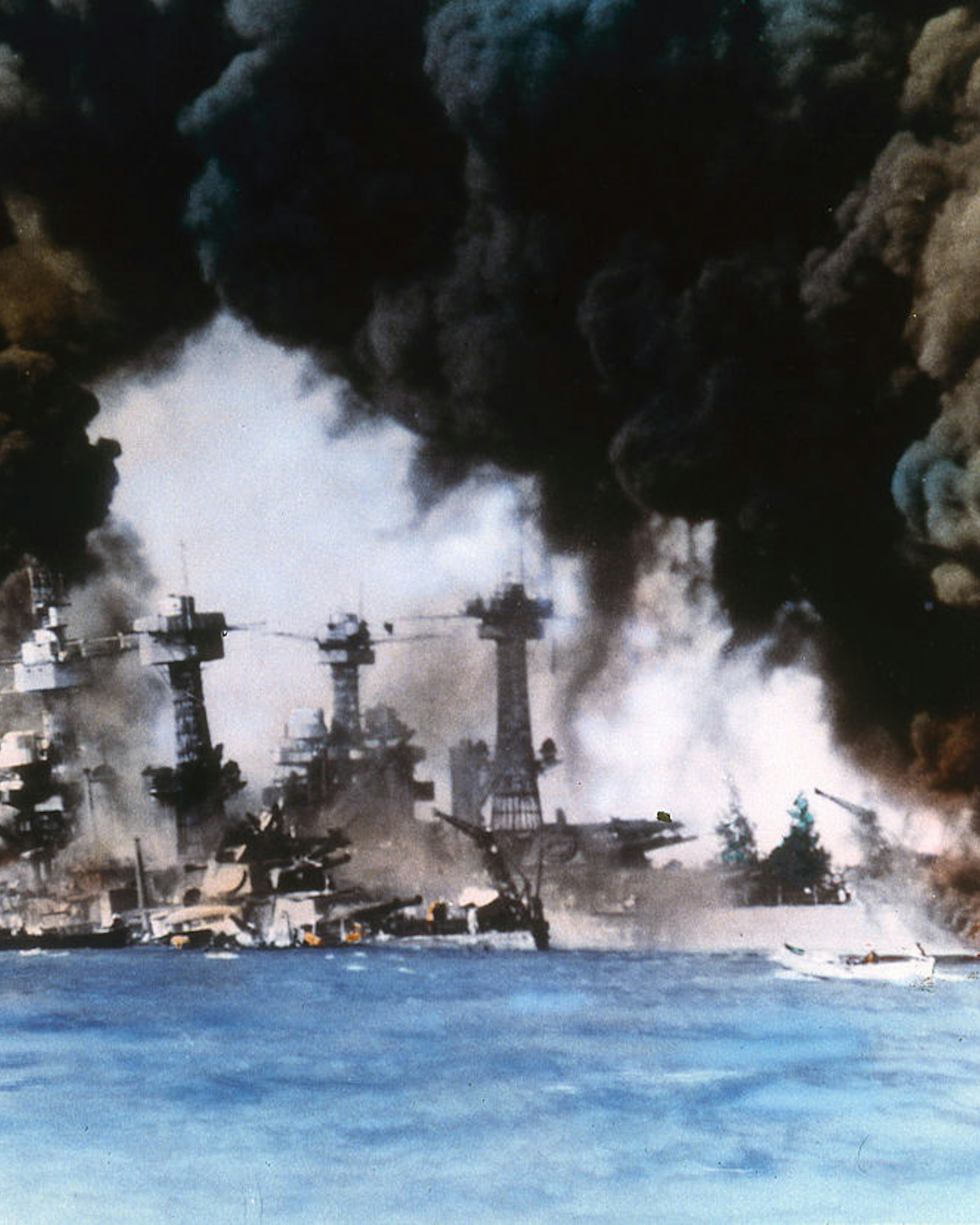 Thick smoke billows up from stricken American warships (from left, USS West Virginia and USS Tennessee) along battleship row during the Japanese attack on Pearl Harbor, Honolulu, Oahu, Hawaii, December 7, 1941. (Photo by US Navy/Interim Archives/Getty Images)