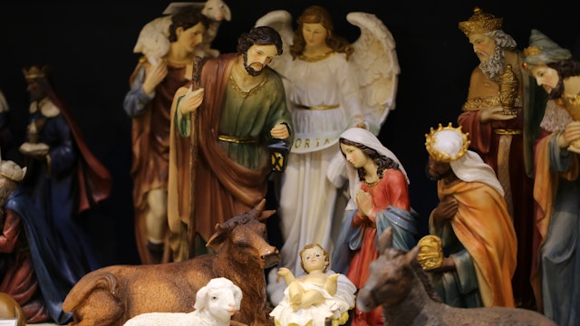 the holy family with baby jesus in plastic for decoration of a crib