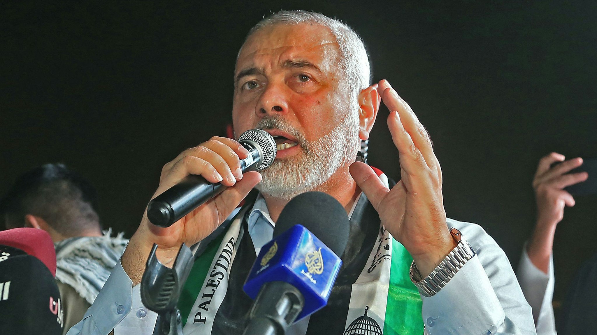 Hamas' political bureau chief Ismail Haniyeh addresses supporters during a rally in solidarity with the Palestinians outside Qatar's Imam Muhammad Abdel-Wahhab Mosque in the capital Doha on May 15, 2021. - Qatar's Foreign Minister hosted the political chief of Palestinian Islamist movement Hamas and called for an end to Israel's bombardment of Gaza, state media said.
