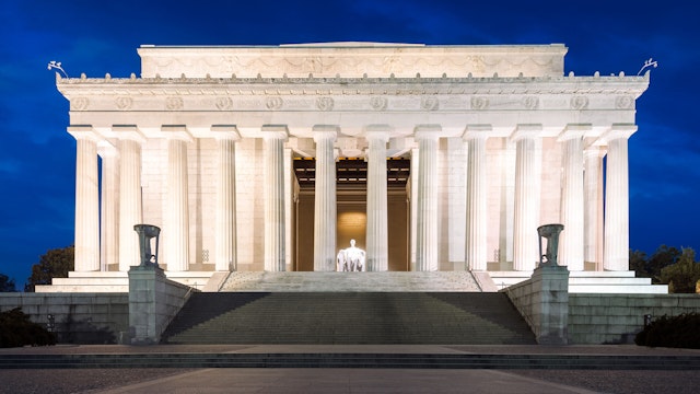 Abraham Lincoln Memorial, Blue Hour, Washington DC, America Photograph taken pre-sunrise The Lincoln Memorial is an American National monument and a major tourist attraction. It was built to honor Abraham Lincoln and dedicated in 1922. The architect was Henry Bacon, Sculptor was Daniel Chester French. The statue was carved by the Piccirilli Brothers and the painter of the murals was Jules Geurin. The statue of Lincoln is 19 feet (5.8m). The Memorial is styled as a classic Greek temple with 36 Doric columns which represented the 36 states n the Union at the time of Lincoln's death. In 1963 Martin Luther King delivered his historic speech "I have a dream".