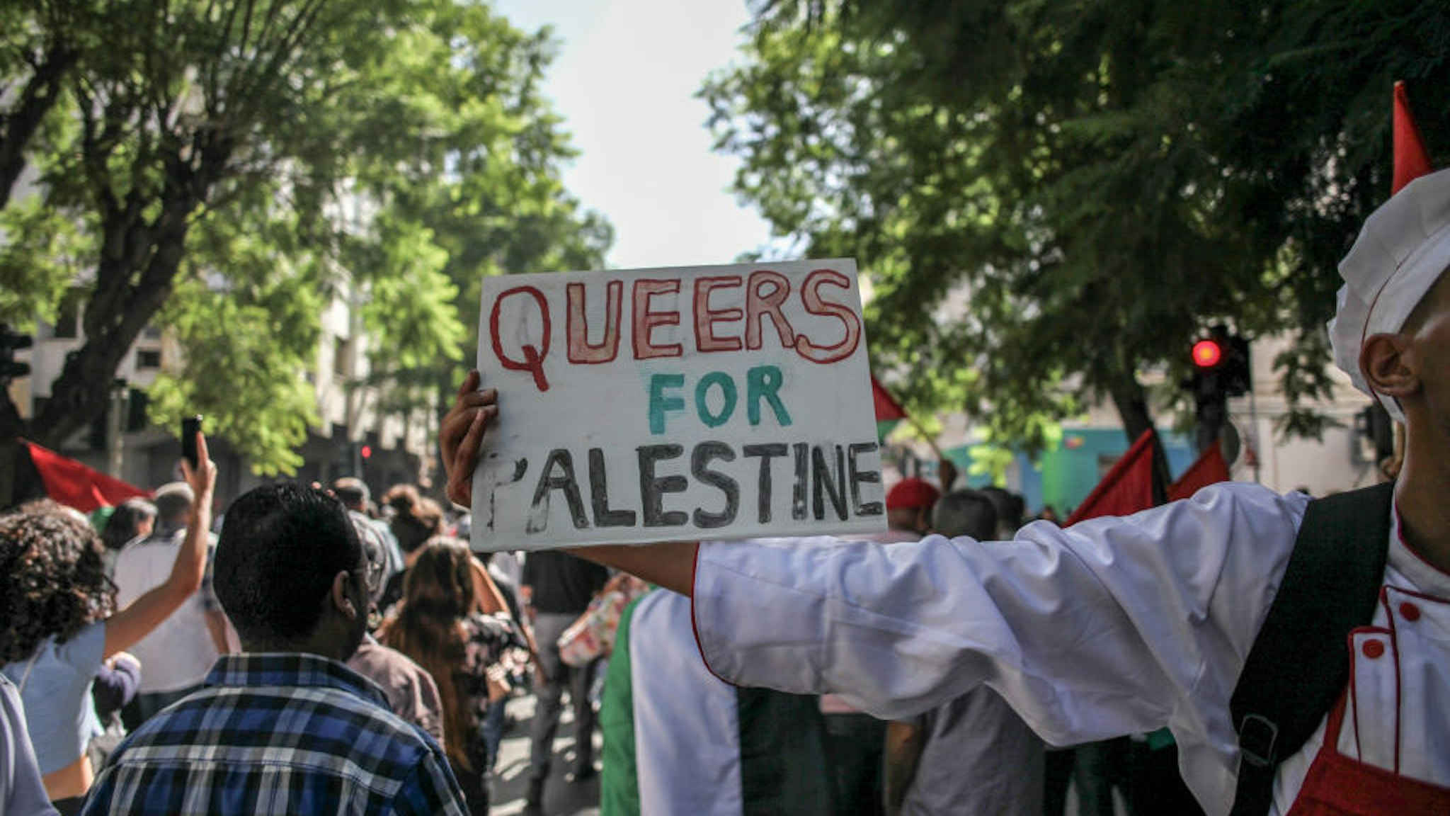 A protester holds up a placard that reads Queers for Palestine during a pro-Palestinian march called by The Tunisian General Labour Union (UGTT) in Tunis, Tunisia, on October 12, 2023. (Photo by Chedly Ben Ibrahim/NurPhoto)