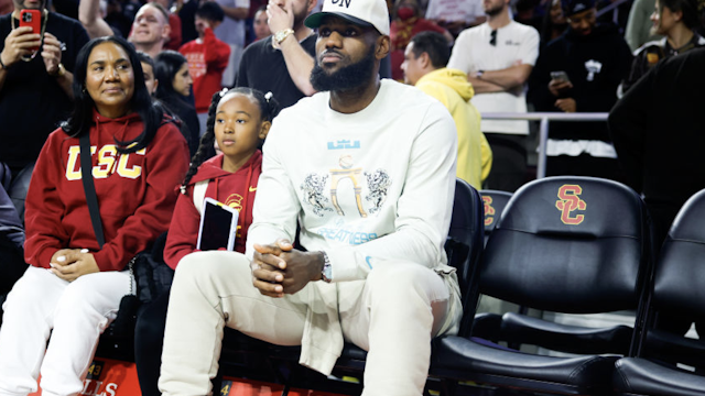 Lakers' LeBron Jame watches the game between the USC Trojans and the Long Beach State 49ers during the first half at Galen Center in Los Angeles Sunday, Dec. 10, 2023.