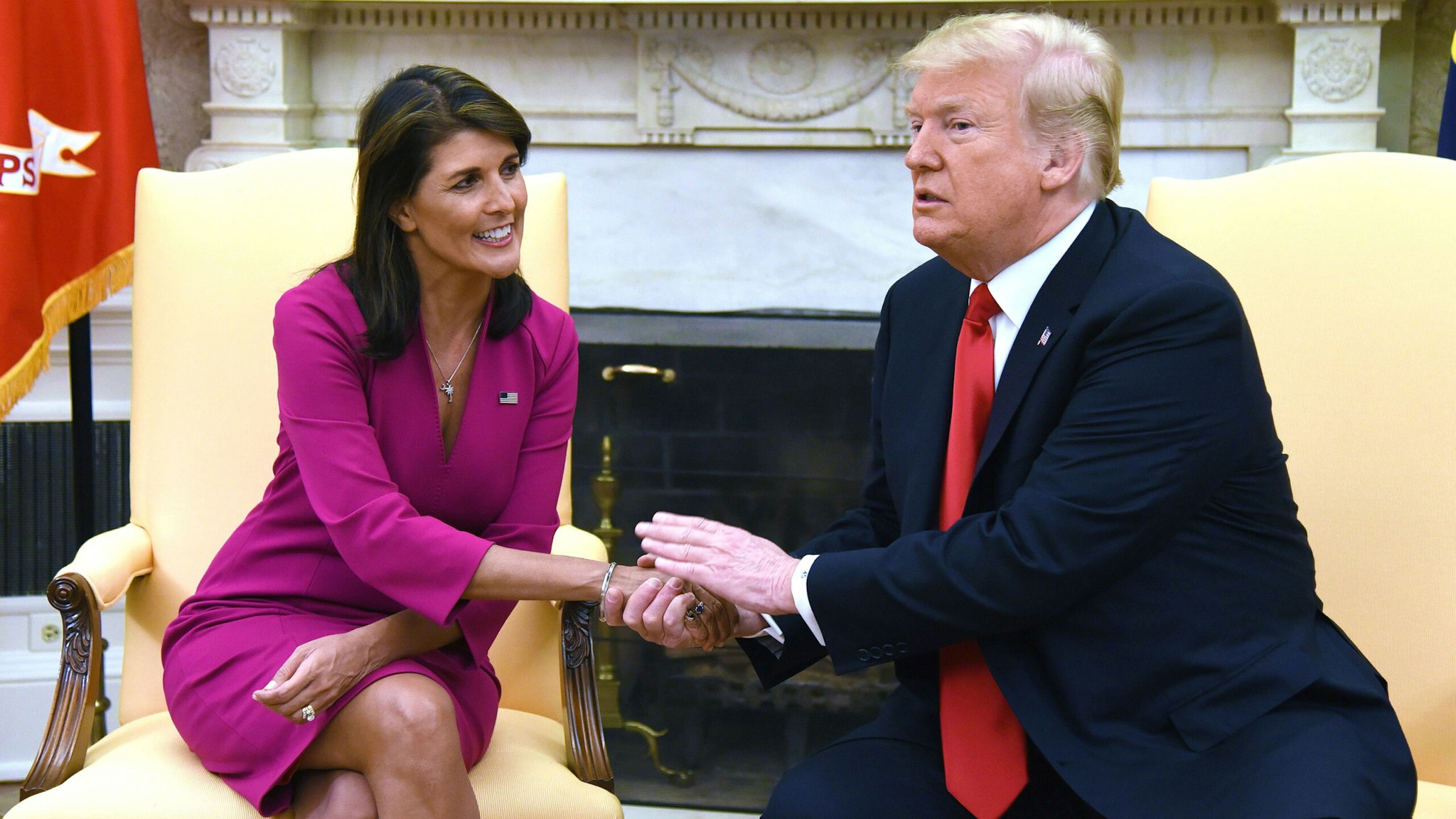 TOPSHOT - US President Donald Trump shakes hands with Nikki Haley, the United States Ambassador to the United Nations in the Oval office of the White House on October 9, 2018 in Washington, DC. - Nikki Haley resigned Tuesday as the US ambassador to the United Nations, in the latest departure from President Donald Trump's national security team. Meeting Haley in the Oval Office, Trump said that Haley had done a "fantastic job" and would leave at the end of the year.