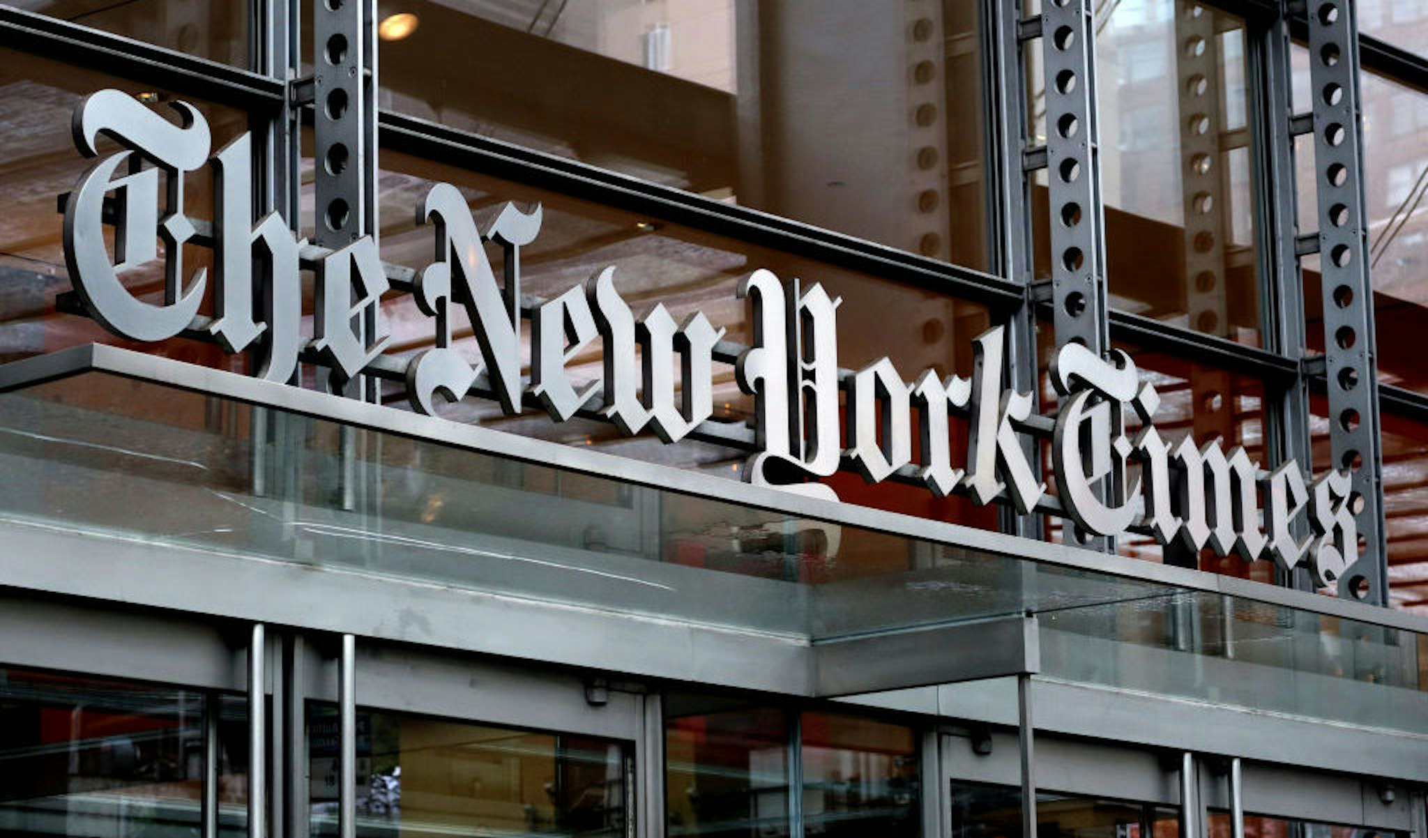The New York Times logo hangs above a doorway of their corporate headquarters on April 29, 2023, in New York City. (Photo by Gary Hershorn/Getty Images)