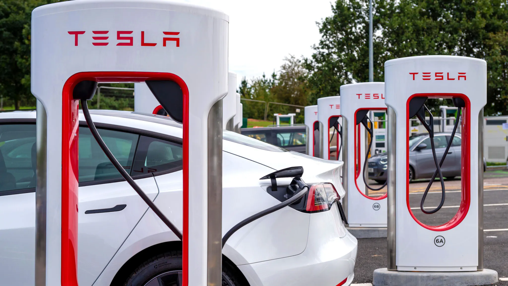 Telsa EV electric vehicle charging EXETER, ENGLAND - SEPTEMBER 23: A general view of a Telsa EV electric vehicle charging at the Tesla only Supercharger network at Moto Exeter M5 Motorway Services charging point on September 23, 2023 in Exeter, England.
