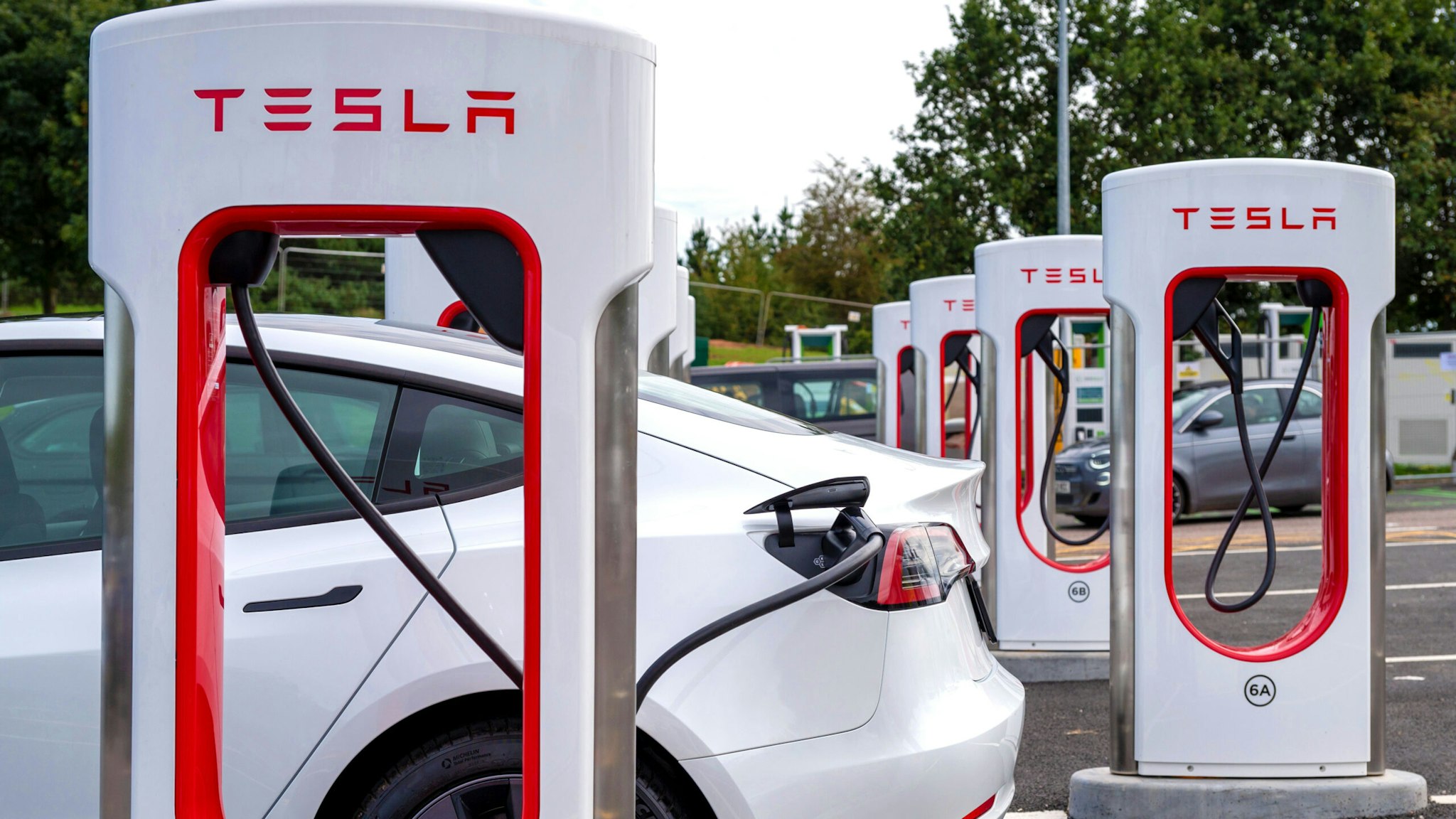 EXETER, ENGLAND - SEPTEMBER 23: A general view of a Telsa EV electric vehicle charging at the Tesla only Supercharger network at Moto Exeter M5 Motorway Services charging point on September 23, 2023 in Exeter, England.