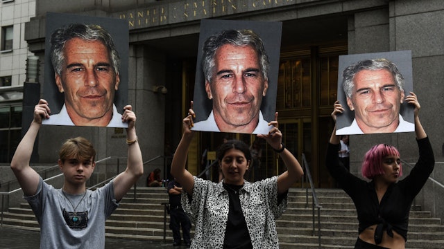 NEW YORK, NY - JULY 08: A protest group called "Hot Mess" hold up signs of Jeffrey Epstein in front of the Federal courthouse on July 8, 2019 in New York City. According to reports, Epstein will be charged with one count of sex trafficking of minors and one count of conspiracy to engage in sex trafficking of minors. (Photo by Stephanie Keith/Getty Images)