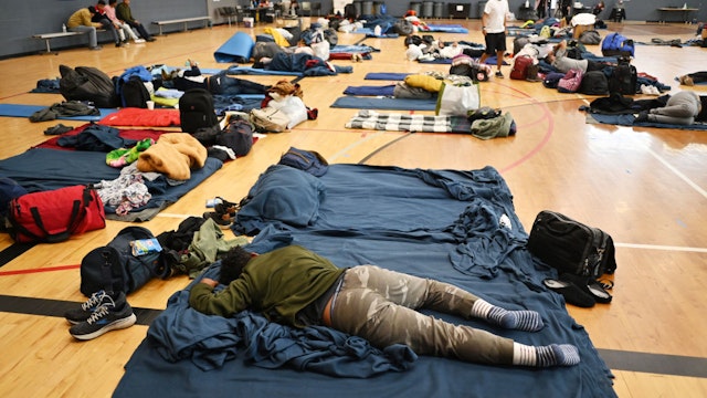 DENVER, CO - JANUARY 13 : A migrant lie on the sleeping pad at a makeshift shelter in Denver, Colorado on Friday, January 13, 2023. (Photo by Hyoung Chang/The Denver Post)