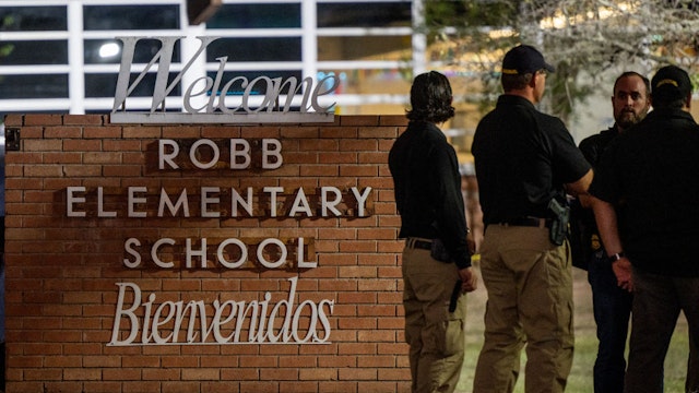 UVALDE, TEXAS - MAY 24: Law enforcement officers speak together outside of Robb Elementary School following the mass shooting at Robb Elementary School on May 24, 2022 in Uvalde, Texas. According to reports, 19 students and 2 adults were killed, with the gunman fatally shot by law enforcement.