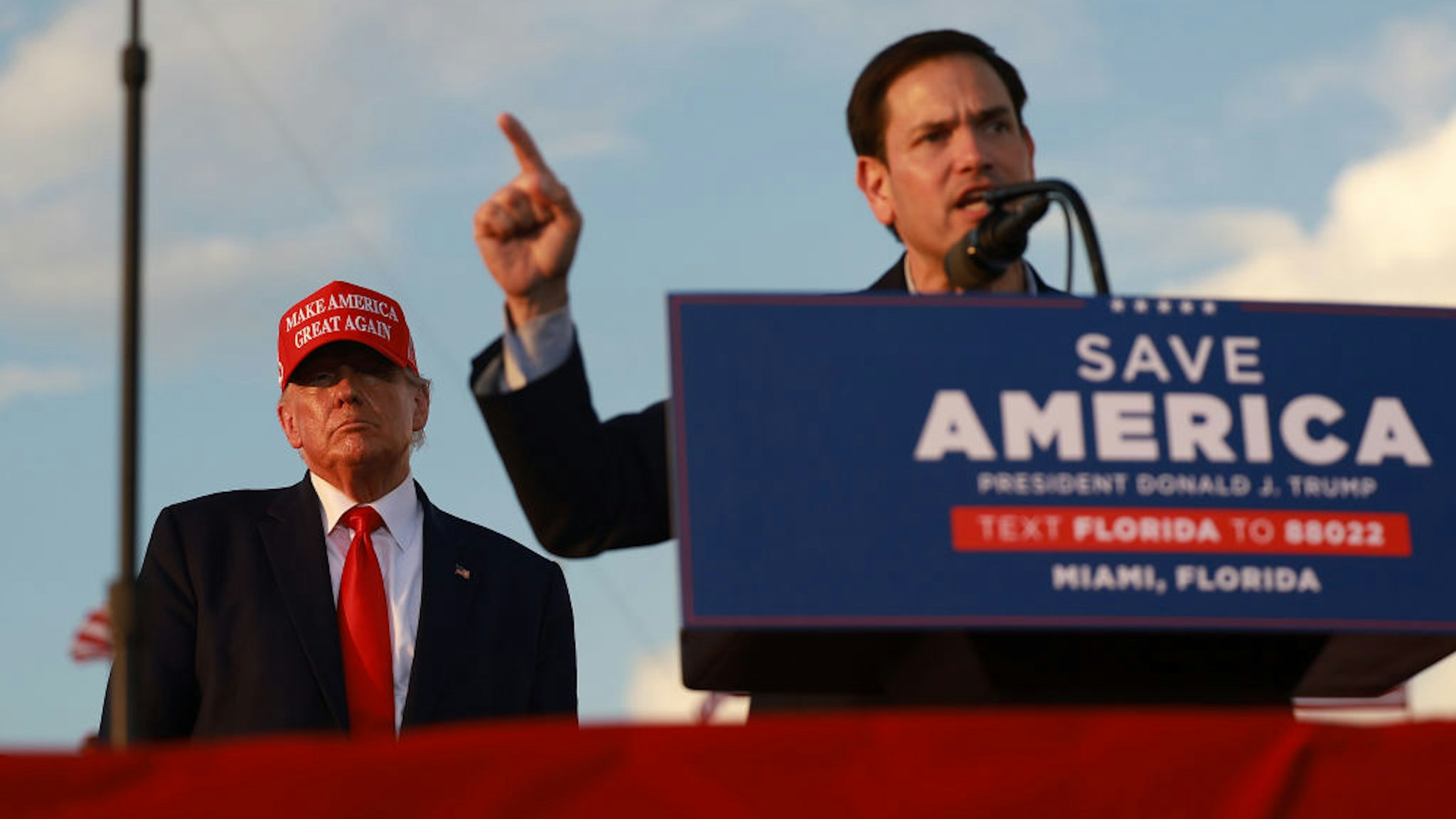 MIAMI, FLORIDA - NOVEMBER 06: Former U.S. President Donald Trump listens as Sen. Marco Rubio (R-FL) speaks during a rally at the Miami-Dade County Fair and Exposition on November 6, 2022 in Miami, Florida. Rubio faces U.S. Rep. Val Demings (D-FL) in his reelection bid in Tuesday's general election.