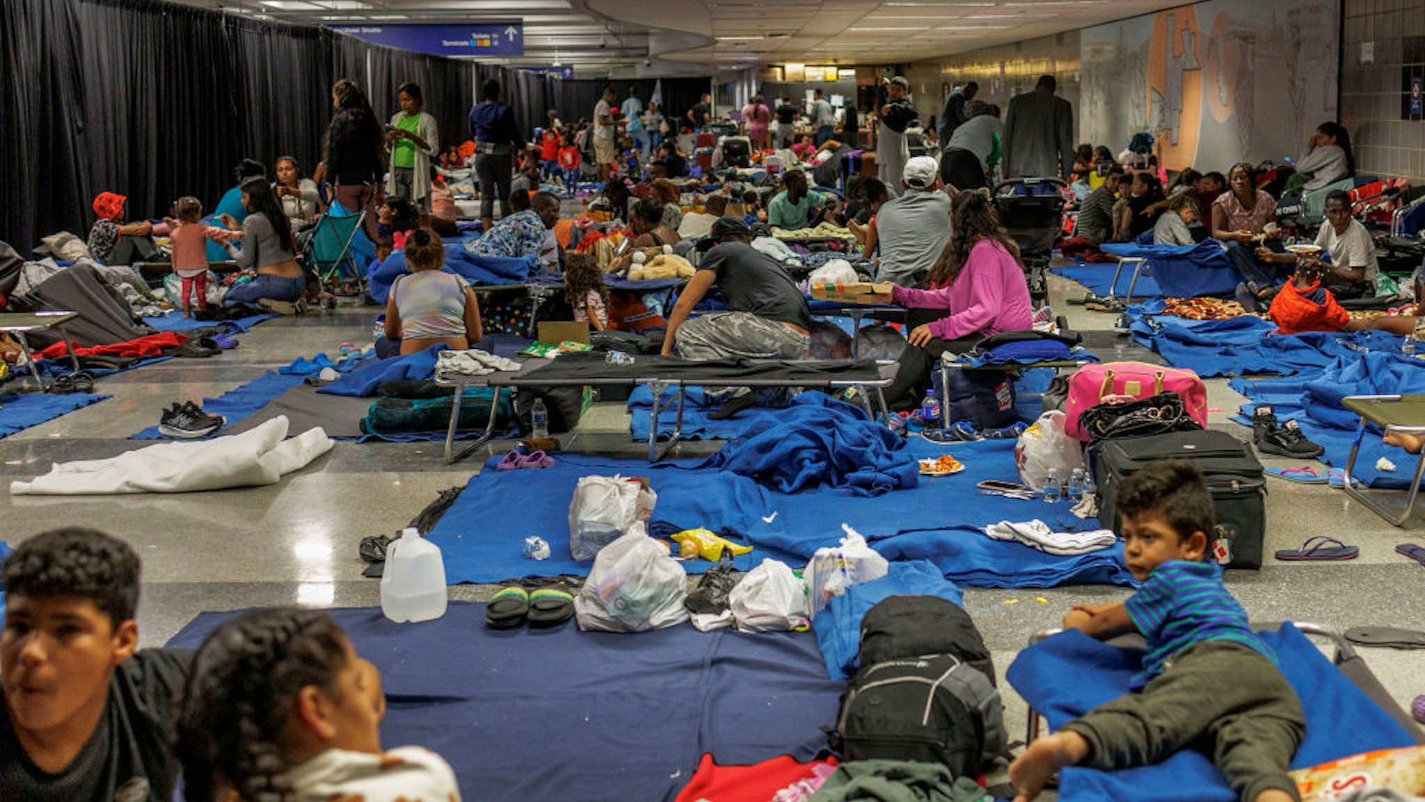 Recently arrived migrants in a makeshift shelter operated by the city of Chicago at O'Hare International Airport on Aug. 31, 2023. (Armando L. Sanchez/Chicago Tribune/Tribune News Service via Getty Images)