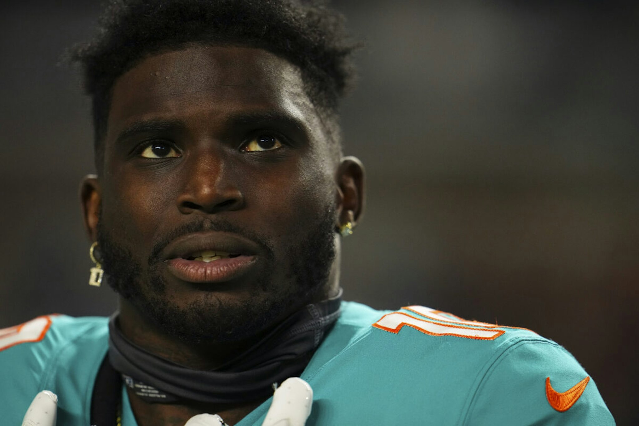 MIAMI GARDENS, FL - DECEMBER 11: Tyreek Hill #10 of the Miami Dolphins looks on from the sideline prior to an NFL football game against the Tennessee Titans at Hard Rock Stadium on December 11, 2023 in Miami Gardens, Florida.