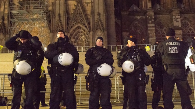 Police officers are seen with submachine guns and are deployed around the Dom Cathedral during the New Year's Eve celebration in Cologne, Germany, on December 31, 2023. German police have arrested three suspects in connection with an alleged terror attack planned for New Year's Eve at the Cologne Dom Cathedral.