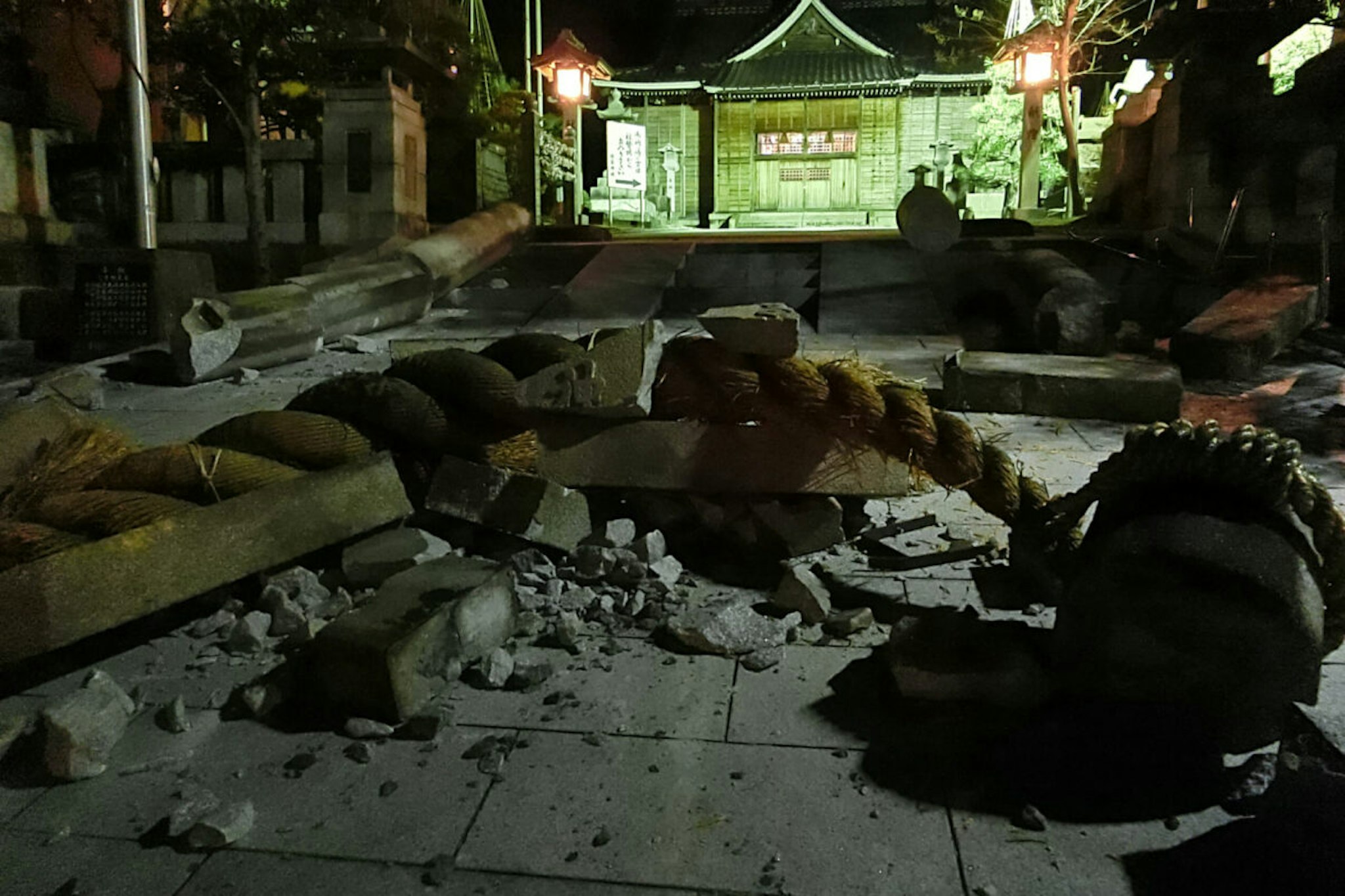 Debris is pictured in the grounds of the Onohiyoshi Shrine in the city of Kanazawa, Ishikawa prefecture, late on January 1, 2024, after it was damaged by a major 7.5 magnitude earthquake which struck the Noto region in Ishikawa prefecture earlier in the day. (Photo by JIJI Press / AFP) / Japan OUT