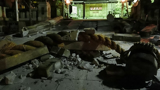 Debris is pictured in the grounds of the Onohiyoshi Shrine in the city of Kanazawa, Ishikawa prefecture, late on January 1, 2024, after it was damaged by a major 7.5 magnitude earthquake which struck the Noto region in Ishikawa prefecture earlier in the day. (Photo by JIJI Press / AFP) / Japan OUT