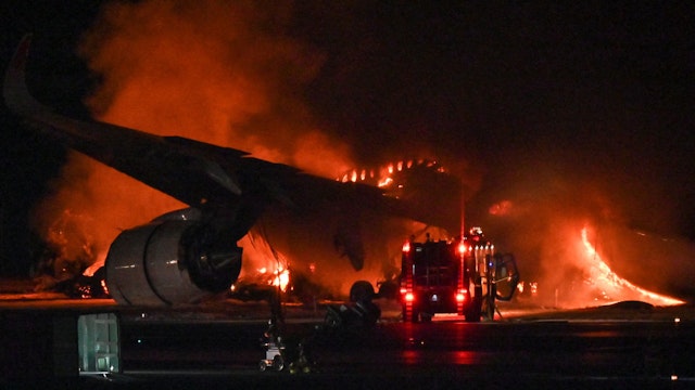 A Japan Airlines (JAL) passenger plane is seen on fire on the tarmac at Tokyo International Airport at Haneda on January 2, 2024. A Japan Airlines plane was in flames on the runway of Tokyo's Haneda Airport on January 2 after apparently colliding with a coast guard aircraft, television reports said.