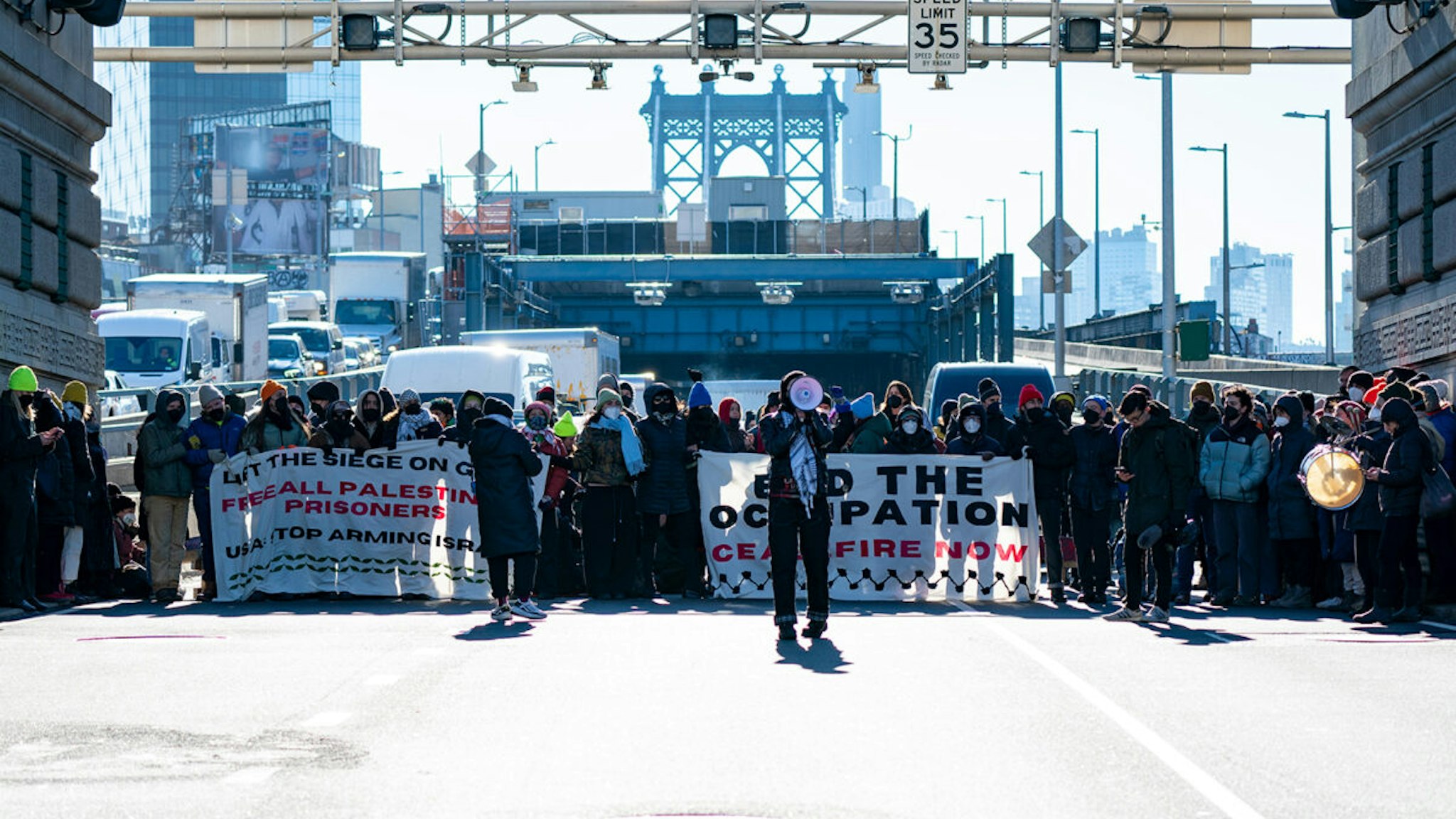 Pro-Palestinian protesters are pictured blocking traffic on the Manhattan Bridge in Manhattan on Monday, Jan. 8, 2024.