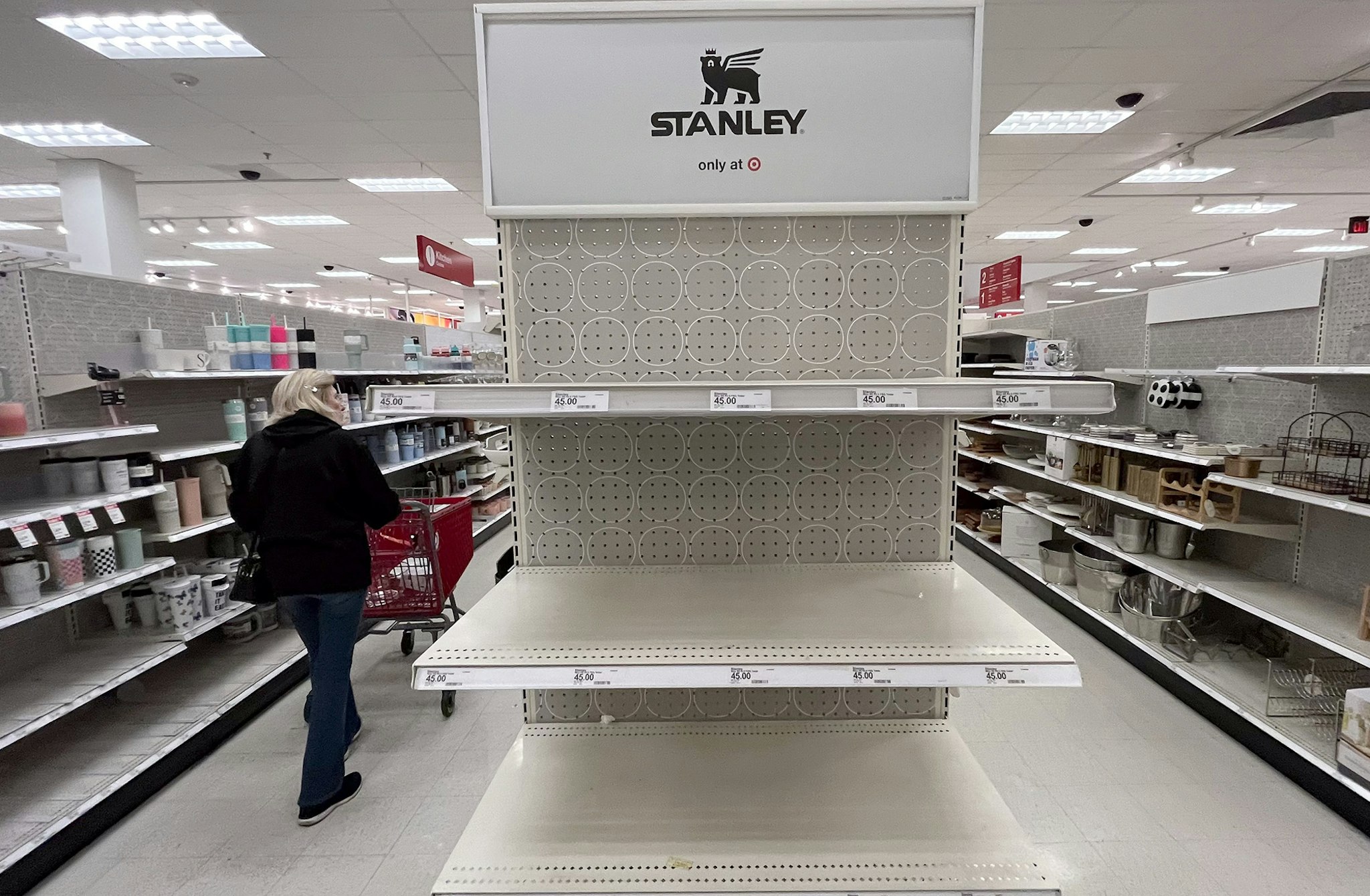 Canoga Park, CA - January 09: A shopper passes empty shelves once stocked with Stanley insulated steel tumblers at a Target store on Tuesday, Jan. 9, 2024 in Canoga Park, CA. The Stanley cups, not the Stanley Cup awarded to the National Hockey League champion, has prompted long lines outside of Target stores in the dead of night. Ugly fights have broken out. Shouting matches have erupted. All this hubbub over insulated steel tumblers sold in various colors at Target and Starbucks. (Brian van der Brug / Los Angeles Times via Getty Images)