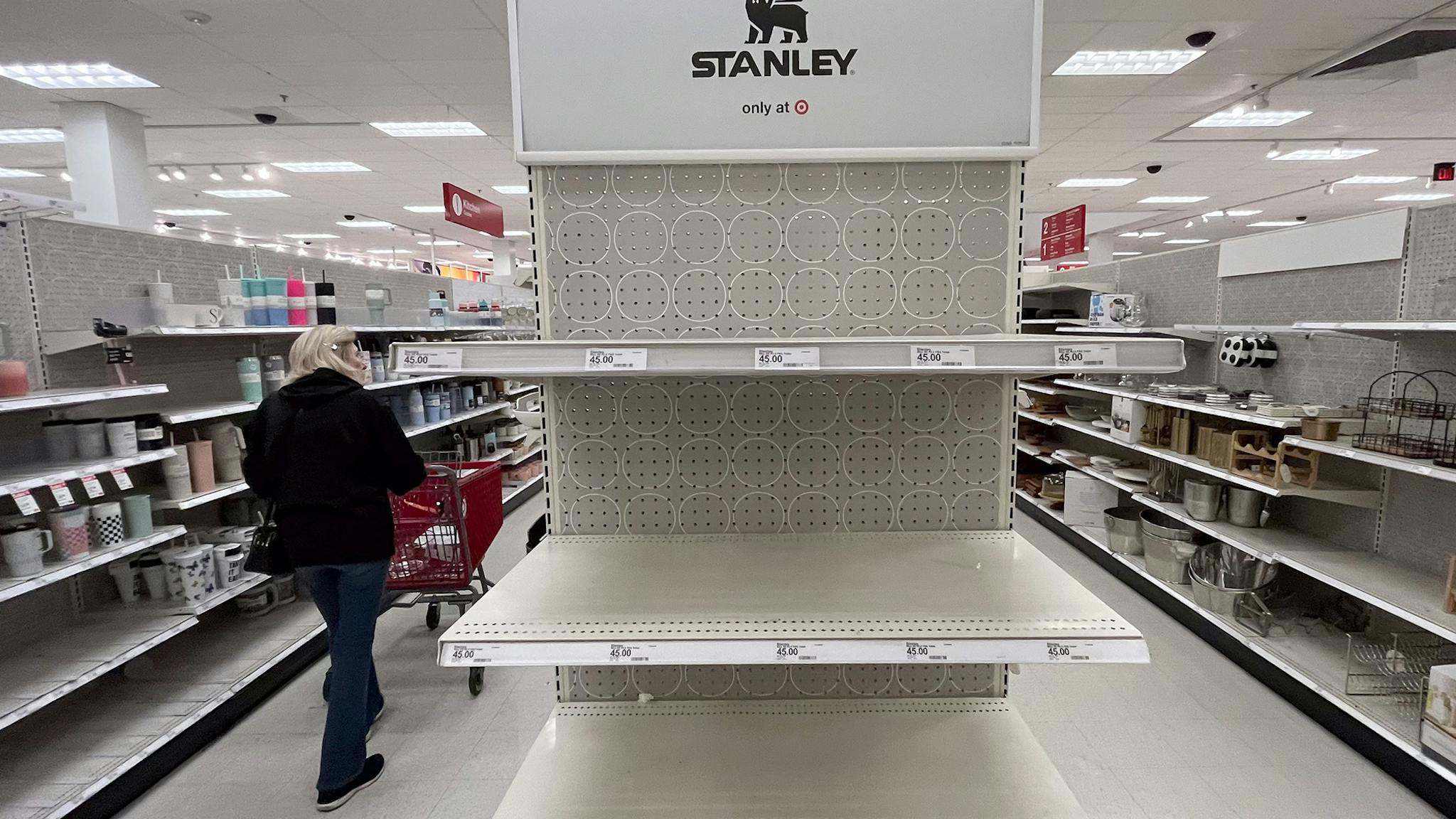 A shopper passes empty shelves once stocked with Stanley insulated steel tumblers Canoga Park, CA - January 09: A shopper passes empty shelves once stocked with Stanley insulated steel tumblers at a Target store on Tuesday, Jan. 9, 2024 in Canoga Park, CA. The Stanley cups, not the Stanley Cup awarded to the National Hockey League champion, has prompted long lines outside of Target stores in the dead of night. Ugly fights have broken out. Shouting matches have erupted. All this hubbub over insulated steel tumblers sold in various colors at Target and Starbucks. (Brian van der Brug / Los Angeles Times via Getty Images)