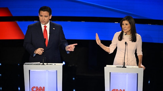 Florida Governor Ron DeSantis (L) and former US Ambassador to the UN Nikki Haley speak during the fifth Republican presidential primary debate at Drake University in Des Moines, Iowa, on January 10, 2024.