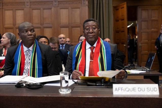 THE HAGUE, NETHERLANDS - JANUARY 11: Vusimuzi Madonsela (R), South African Amabassador to the Netherlands, and Ronald Lamola, South African Minister of Justice, attend a hearing as South Africa has requested the court to indicate measures concerning alleged violations of human rights by Israel in the Gaza Strip on January 11, 2024 in The Hague, Netherlands. On January 11 and January 12 at the International Court of Justice (ICJ), the judicial body of the United Nations, in The Hague, South Africa seized the ICJ, to ask it to rule on possible acts of "genocide" in the Gaza Strip by Israel. (Photo by Michel Porro/Getty Images)