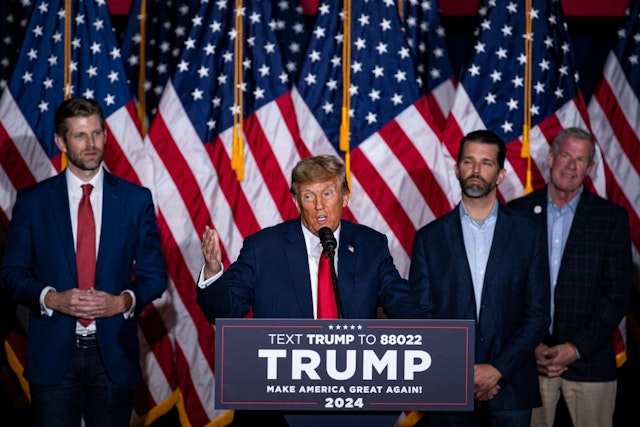 Former US President Donald Trump, second left, speaks at a caucus night watch party in Des Moines, Iowa, US, on Monday, Jan. 15, 2024. Trump cruised to victory in the Iowa caucus, warding off a late challenge from rivals Ron DeSantis and Nikki Haley and cementing his status as the clear Republican frontrunner in the race. Photographer: Al Drago/Bloomberg via Getty Images