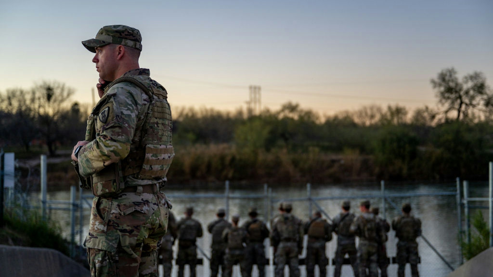 EAGLE PASS, TEXAS - JANUARY 12: National Guard soldiers stand guard on the banks of the Rio Grande river at Shelby Park on January 12, 2024 in Eagle Pass, Texas. The Texas National Guard continues its blockade and surveillance of Shelby Park in an effort to deter illegal immigration. The Department of Justice has accused the Texas National Guard of blocking Border Patrol agents from carrying out their duties along the river.