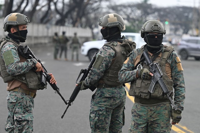 Soldiers guard the surroundings of the Simon Bolivar Air Base in Guayaquil, Ecuador, on January 19, 2024, following the arrival of relatives of Ecuadorean drug lord Adolfo Macias, alias "Fito.". The wife and children of Ecuadorean drug lord Adolfo Macias, alias "Fito," who recently escaped from a prison in Guayaquil, were detained in central Argentina and expelled from the country, authorities said Friday. (Photo by Marcos PIN / AFP) (Photo by MARCOS PIN/AFP via Getty Images)