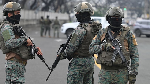 Soldiers guard the surroundings of the Simon Bolivar Air Base in Guayaquil, Ecuador, on January 19, 2024, following the arrival of relatives of Ecuadorean drug lord Adolfo Macias, alias "Fito.". The wife and children of Ecuadorean drug lord Adolfo Macias, alias "Fito," who recently escaped from a prison in Guayaquil, were detained in central Argentina and expelled from the country, authorities said Friday. (Photo by Marcos PIN / AFP) (Photo by MARCOS PIN/AFP via Getty Images)