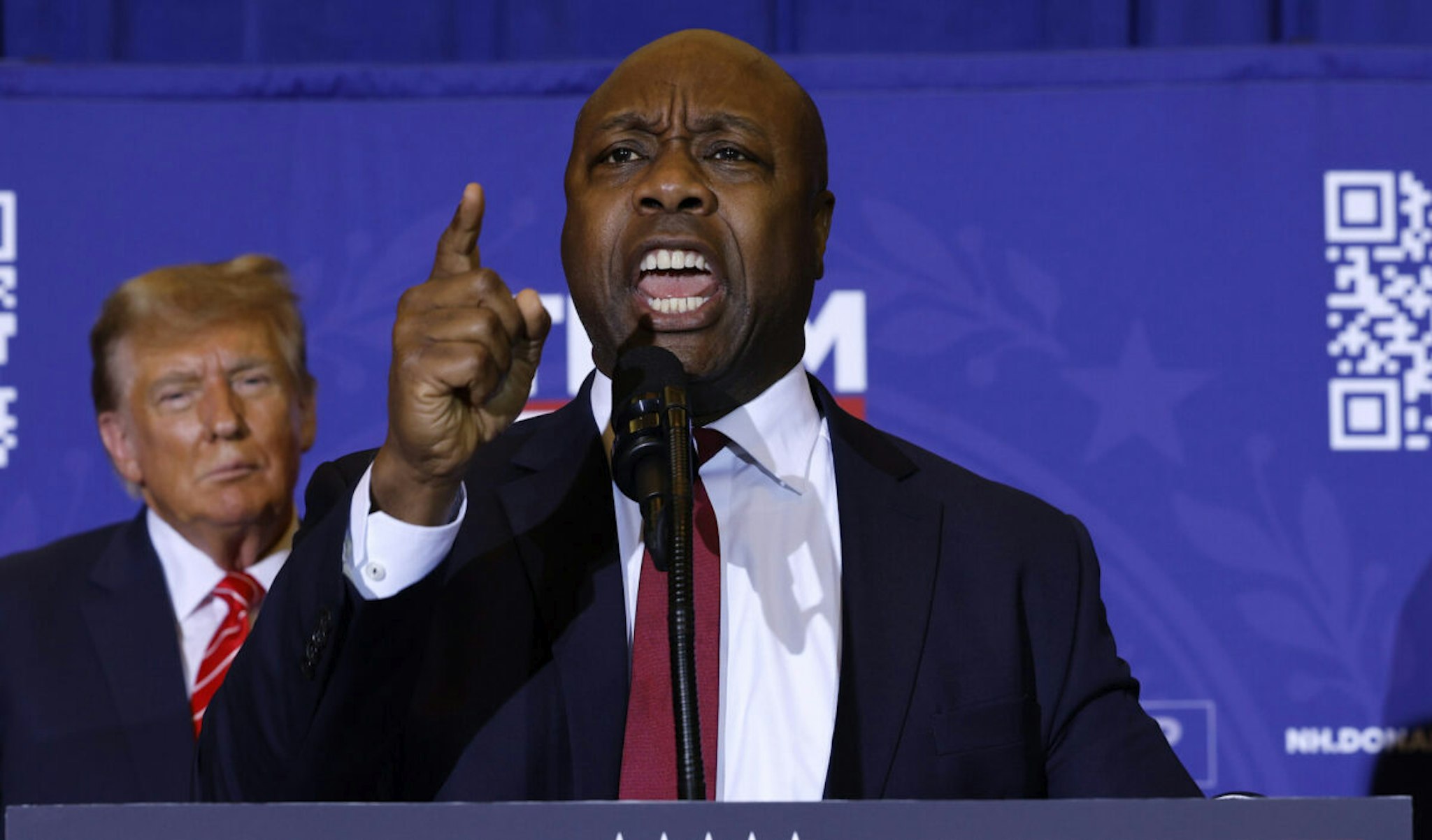 Sen. Tim Scott (R-SC) speaks as Republican presidential candidate and former President Donald Trump looks on during a campaign rally at the Grappone Convention Center on January 19, 2024 in Concord, New Hampshire.