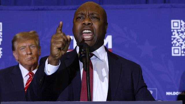 Sen. Tim Scott (R-SC) speaks as Republican presidential candidate and former President Donald Trump looks on during a campaign rally at the Grappone Convention Center on January 19, 2024 in Concord, New Hampshire.