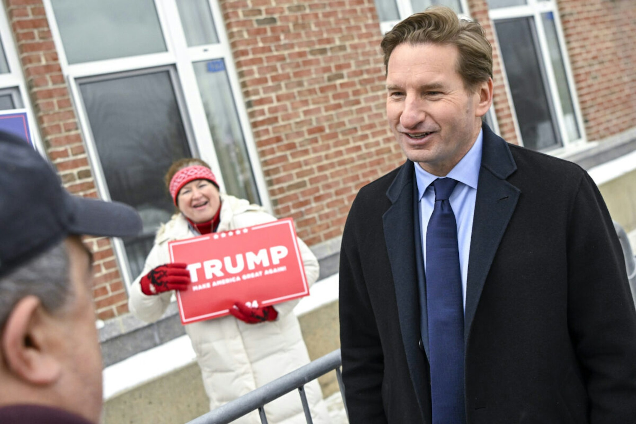 Representative Dean Phillips, a Democrat from Minnesota and 2024 Democratic presidential candidate, right, speaks with voters outside Windham High School in Windham, New Hampshire, US, on Tuesday, Jan. 23, 2024.