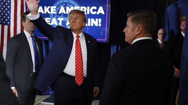LACONIA, NEW HAMPSHIRE - JANUARY 22: Republican presidential candidate and former President Donald Trump waves goodbye to supporters at the conclusion of a campaign rally in the basement ballroom of The Margate Resort on January 22, 2024 in Laconia, New Hampshire. Trump is rallying supporters the day before New Hampshire voters will weigh in on the Republican nominating race with the first-in-the-nation primary.