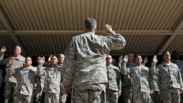 ARLINGTON, VA - JULY 01: U.S. Army Chief of Staff Gen. George Casey (back to camera) administers the oath to 16 soldiers who re-enlisted in the U.S. Army at the Pentagon July 1, 2008 in Arlington, Virginia. The ceremony marked the 35th anniversary of the end of the draft and the beginning of the all-volunteer armed forces. (Photo by Chip Somodevilla/Getty Images)