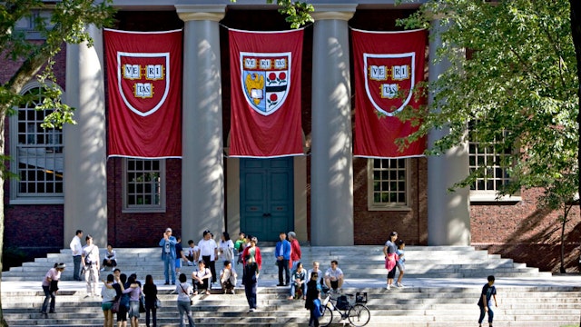 UNITED STATES - SEPTEMBER 03: Harvard banners hang outside Memorial Church on the Harvard University campus in Cambridge, Massachusetts, U.S., on Friday, Sept. 4, 2009. Community activists in Allston, a section of Boston across the Charles River from Harvard's main campus in Cambridge, say university delays have left a (Photo by Michael Fein/Bloomberg via Getty Images)