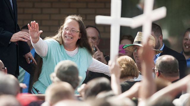 owan County Clerk of Courts Kim Davis waves to a crowd of her supporters at a rally in front of the Carter County Detention Center on September 8, 2015 in Grayson, Kentucky.