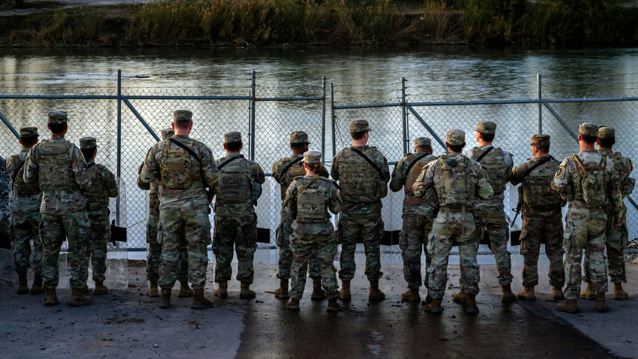 EAGLE PASS, TEXAS - JANUARY 12: National Guard soldiers stand guard on the banks of the Rio Grande river at Shelby Park on January 12, 2024 in Eagle Pass, Texas. The Texas National Guard continues its blockade and surveillance of Shelby Park in an effort to deter illegal immigration. The Department of Justice has accused the Texas National Guard of blocking Border Patrol agents from carrying out their duties along the river.