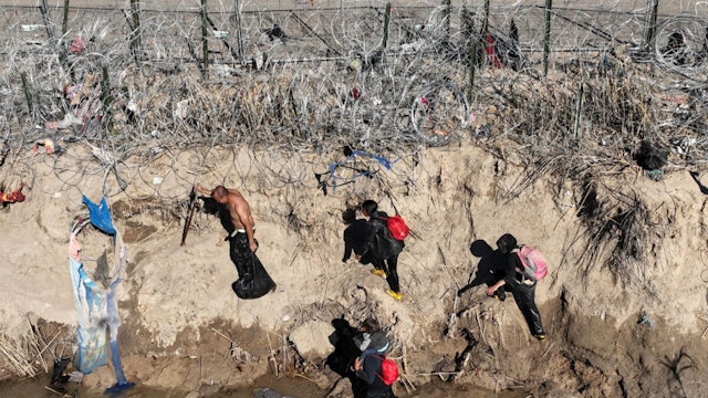 EAGLE PASS, TEXAS - JANUARY 28: An aerial view of the area as migrants walking along razor wire after crossing the Rio Grande into the United States on January 28, 2024 in Eagle Pass, Texas.
