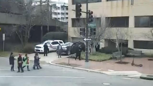 Police officers mill about and let children cross the road after a bomb was reported outside the DNC while Kamala Harris was inside on January 6. / US House of Representatives