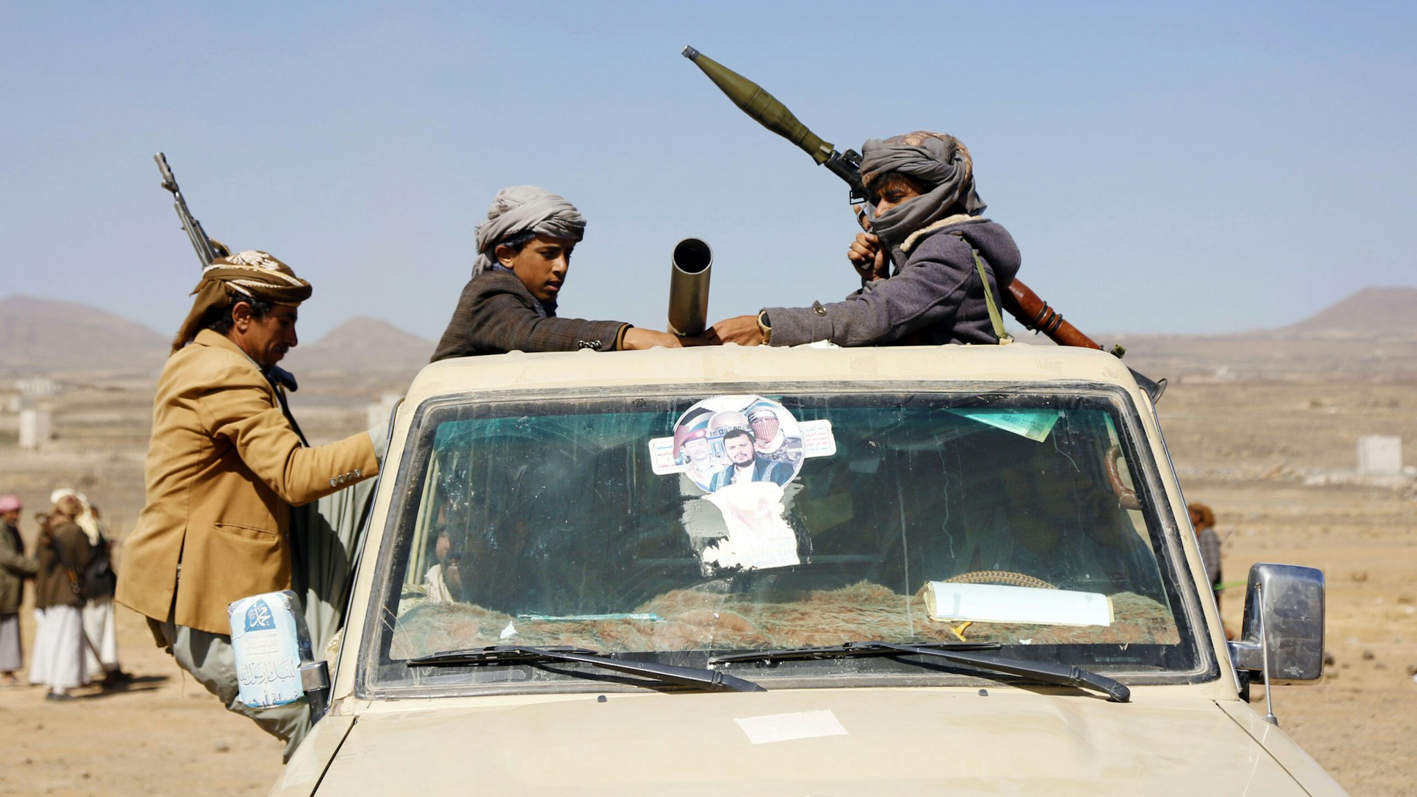 SANA'A, YEMEN - JANUARY 14: Houthi followers ride a vehicle with a machine gun during a tribal gathering on January 14, 2024 on the outskirts of Sana'a, Yemen. Houthi followers gathered to protest against the U.S.-U.K. airstrikes on positions in areas under their control.