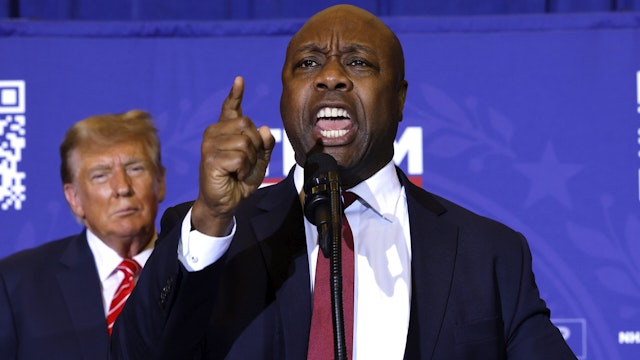 CONCORD, NEW HAMPSHIRE - JANUARY 19: Sen. Tim Scott (R-SC) speaks as Republican presidential candidate and former President Donald Trump looks on during a campaign rally at the Grappone Convention Center on January 19, 2024 in Concord, New Hampshire. New Hampshire voters will weigh in next week on the Republican nominating race with their first-in-the-nation primary, about one week after Trump's record-setting win in the Iowa caucuses. Former UN Ambassador and former South Carolina Gov. Nikki Haley is hoping for a strong second-place showing so to continue her campaign into Nevada and South Carolina.